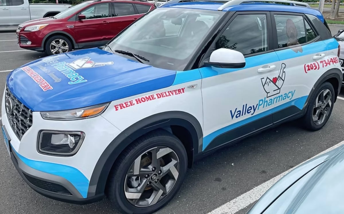 Valley Pharmacy branded delivery vehicle with FREE HOME DELIVERY lettering
